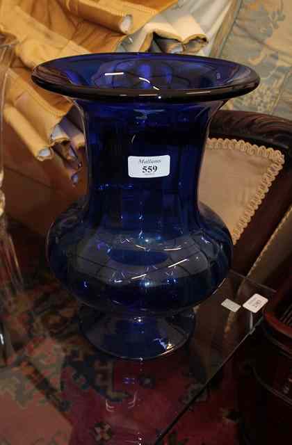 Appraisal: A BLUE GLASS VASE with flaring rim and standing on