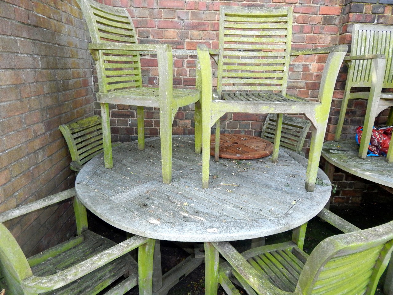 Appraisal: A circular garden table and six carver chairs