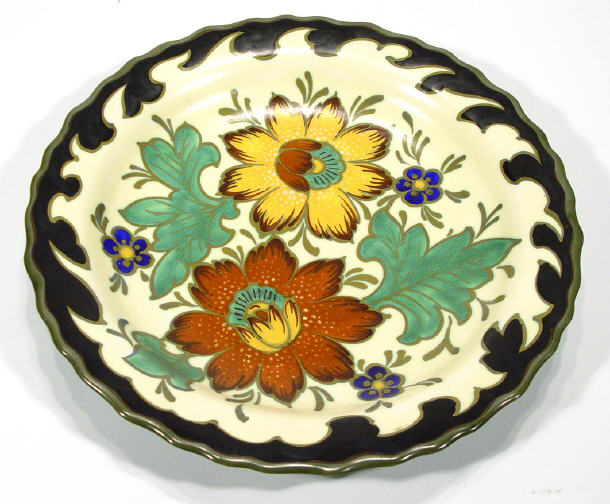 Appraisal: Gouda pottery charger hand painted with flowers onto a cream