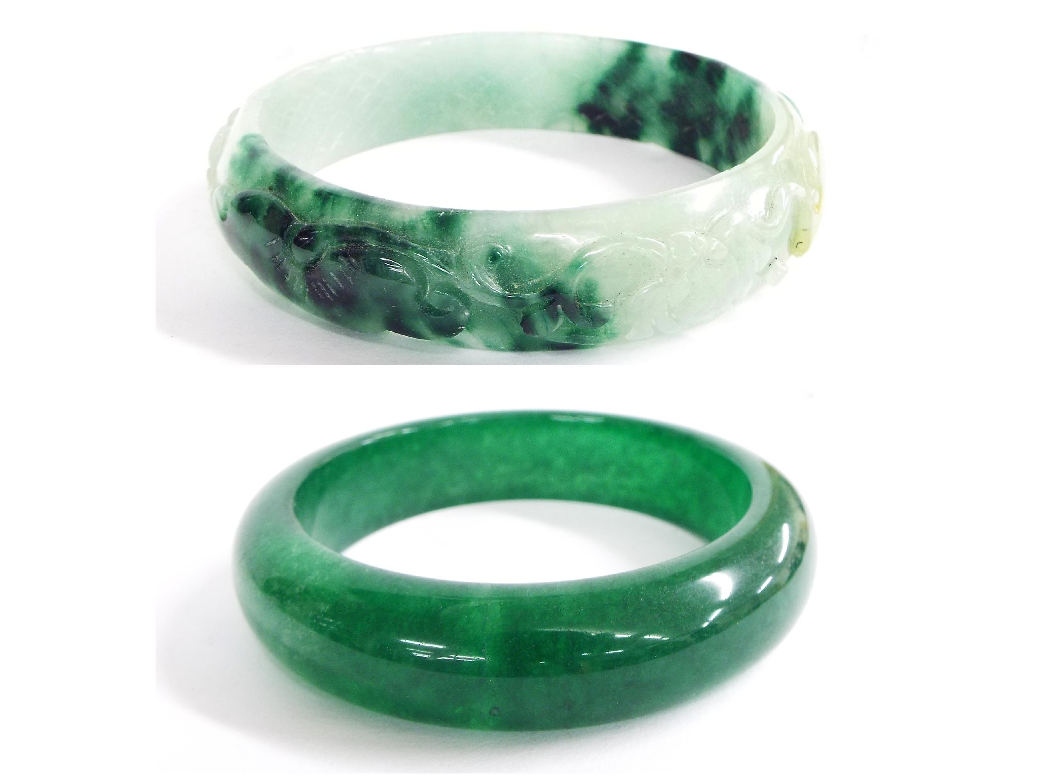 Appraisal: Two similar Chinese green hardstone bangles possibly jade