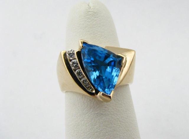 Appraisal: K yellow gold blue topaz and diamond ring with fancy