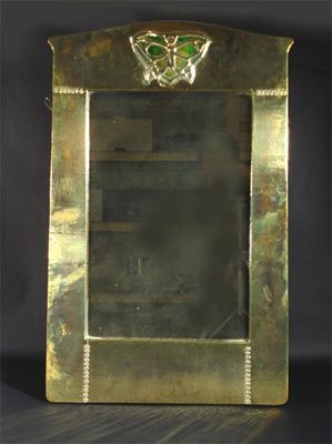 Appraisal: A Liberty Co brass wall mirror cast with a butterfly