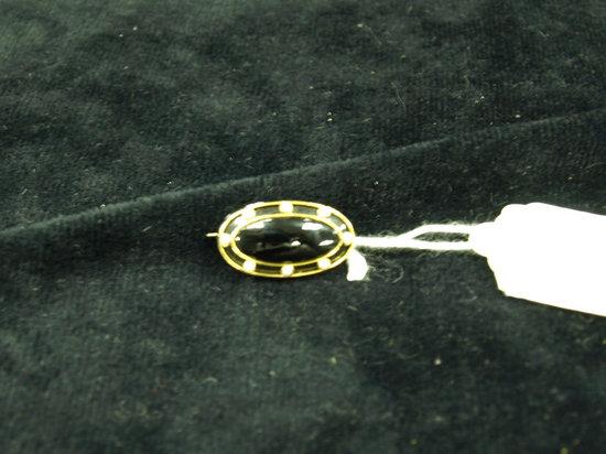 Appraisal: An oval jet brooch with half pearl set border in