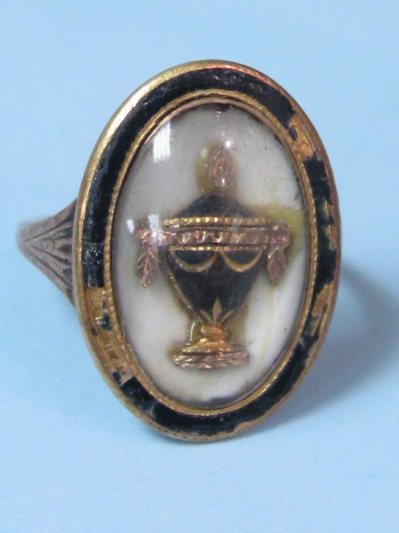 Appraisal: A Georgian Mourning Ring with central urn having blue enamel