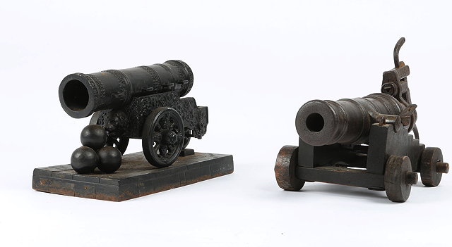 Appraisal: AN ANTIQUE IRON MODEL of a cannon on wooden carriage