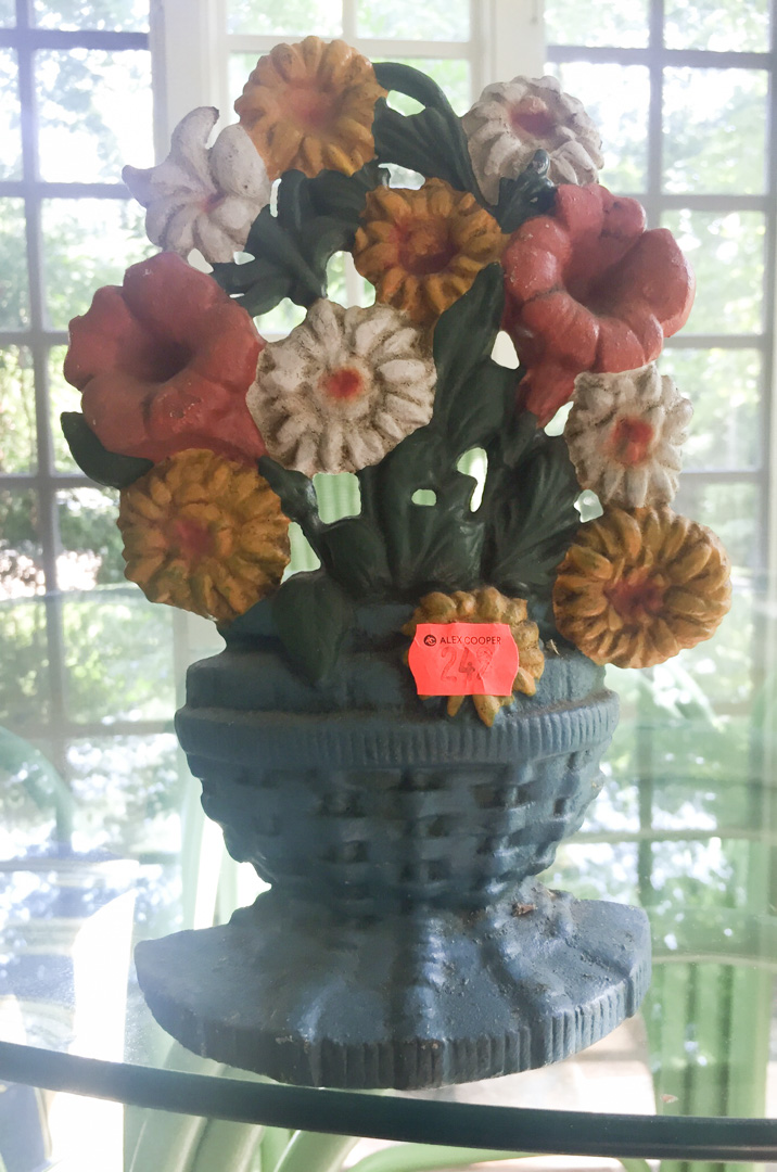 Appraisal: Painted cast iron floral basket door stop