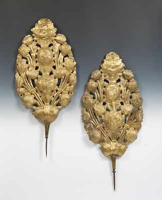 Appraisal: A Pair of Gilt Repousse Flame Shields A northern European