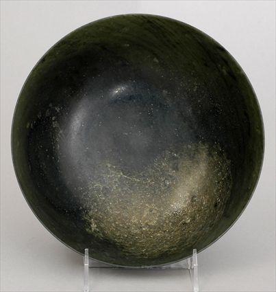 Appraisal: CHINESE SPINACH GREEN JADE FOOTED BOWL The unembellished hemispherical bowl