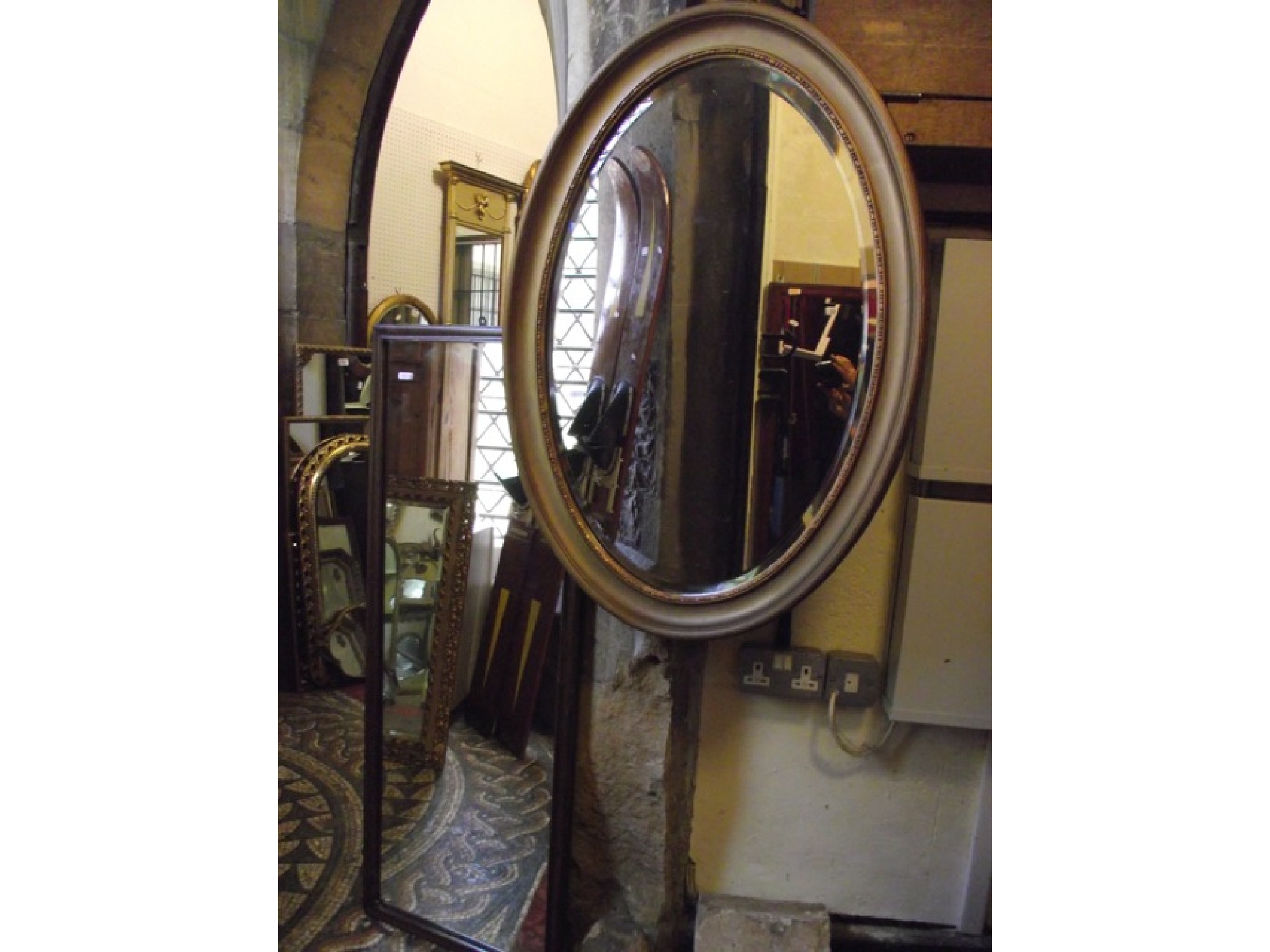 Appraisal: An Edwardian gilt frame wall mirror of oval form with