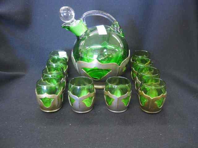 Appraisal: Farber Emerald Glass Decanterwith glasses metalwork holders deco style