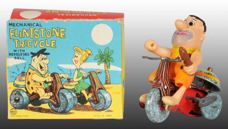 Appraisal: Marx Tin Celluloid Fred Flintstone Tricycle Toy Description Wind-up working