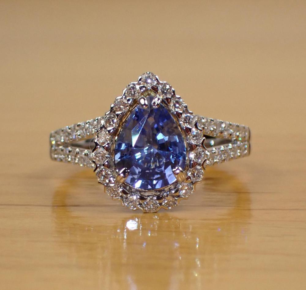 Appraisal: SAPPHIRE DIAMOND AND FOURTEEN WHITE GOLD RING with round-cut diamonds