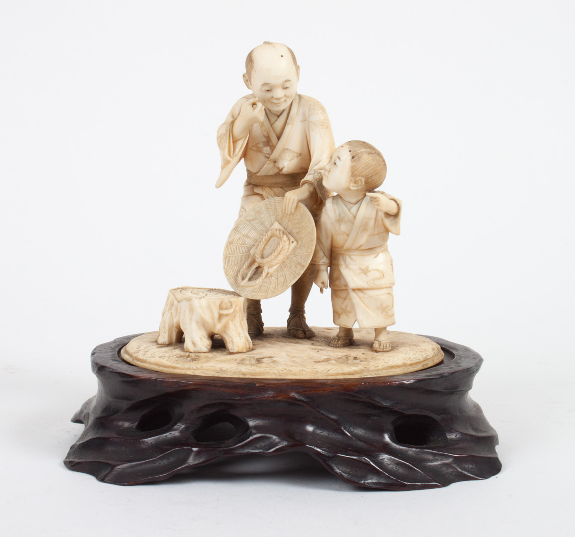 Appraisal: Japanese carved ivory figural group late th century modeled as