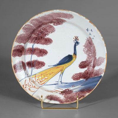 Appraisal: Delft peacock plate standing yellow and blue peacock between sponged