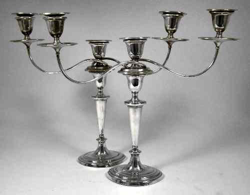 Appraisal: A pair of George III silver pillar candlesticks with oval