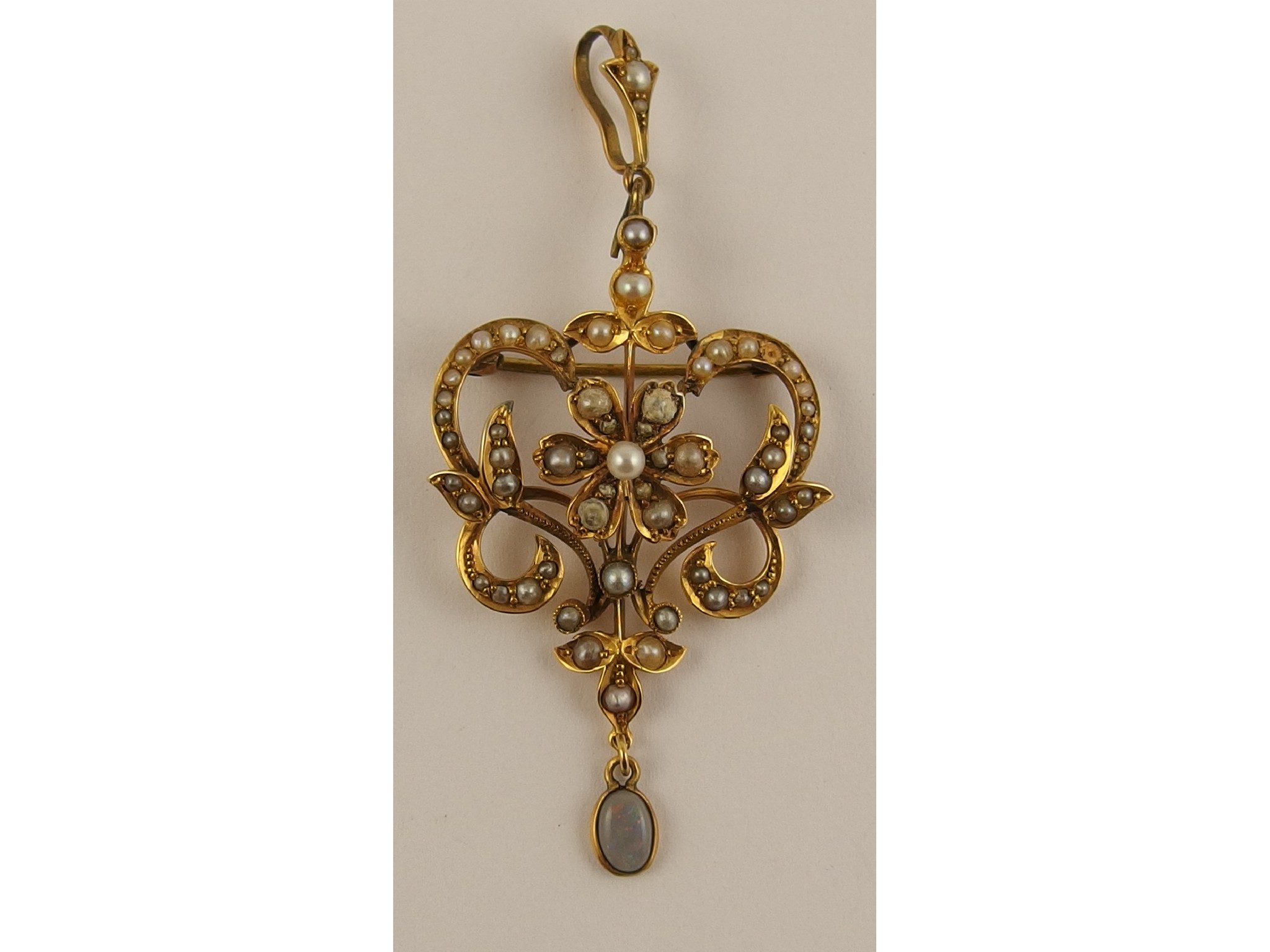 Appraisal: An Edwardian ct opal and seed pearl pendant brooch