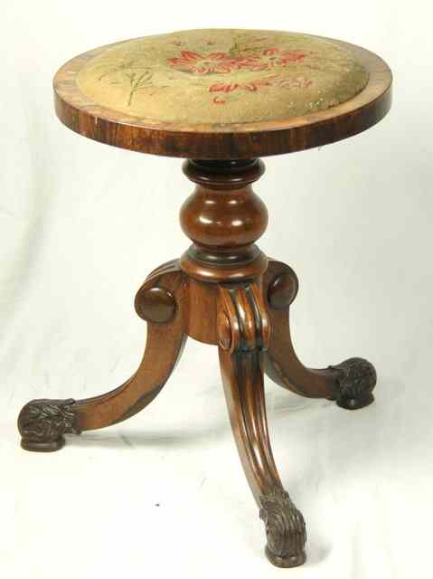 Appraisal: A rosewood piano stool with needlework seat and carved tripod