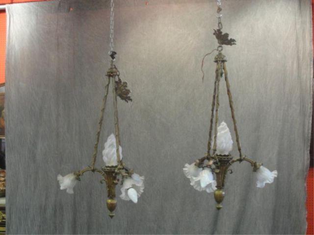 Appraisal: Pair of Bronze Arm Light Chandeliers One shade damaged From