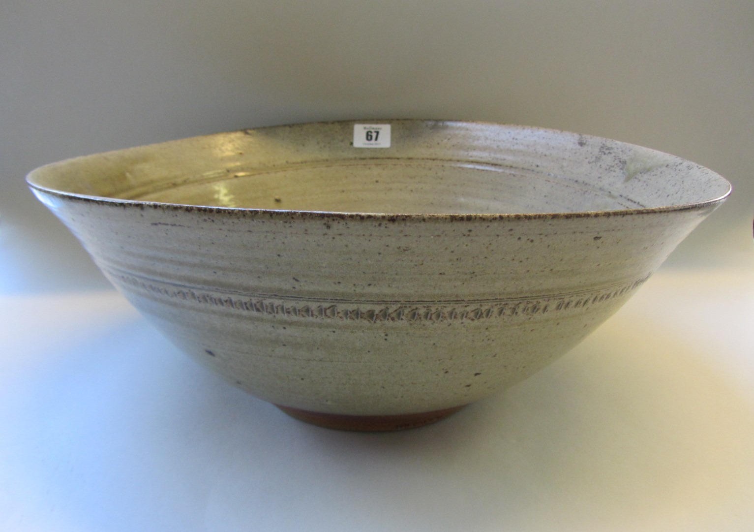 Appraisal: An studio pottery celadon glazed stoneware bowl of circular mis-shapen