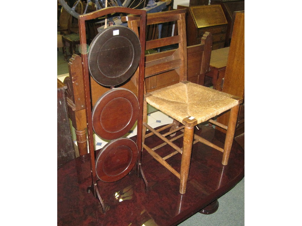 Appraisal: Lot comprising three tier folded cakestand and a rush seated