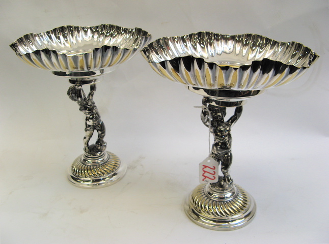 Appraisal: PAIR VICTORIAN STYLE SILVER PLATED COMPOTES with figural putti raised