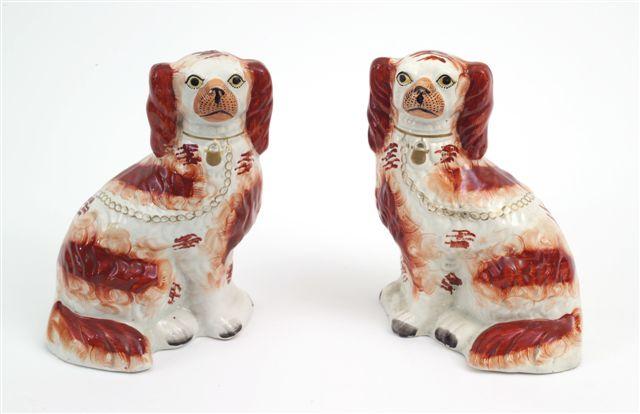 Appraisal: PAIR OF STAFFORDSHIRE MODELS OF SEATED SPANIELS th CENTURY the