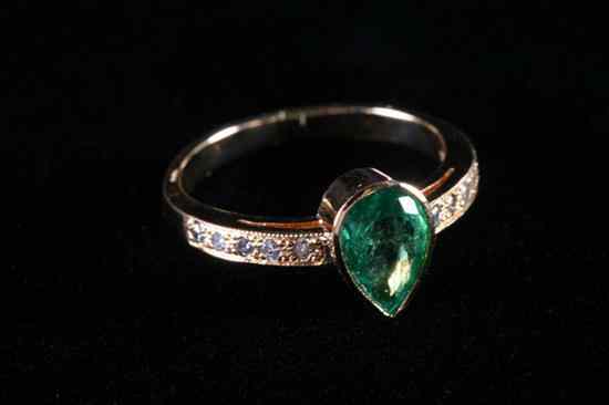 Appraisal: K YELLOW GOLD EMERALD AND DIAMOND RING Pear shape emerald