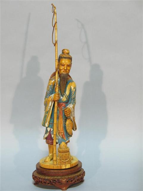 Appraisal: CHINESE POLYCHROMED IVORY FIGURE OF A FISHERMAN Formed as a