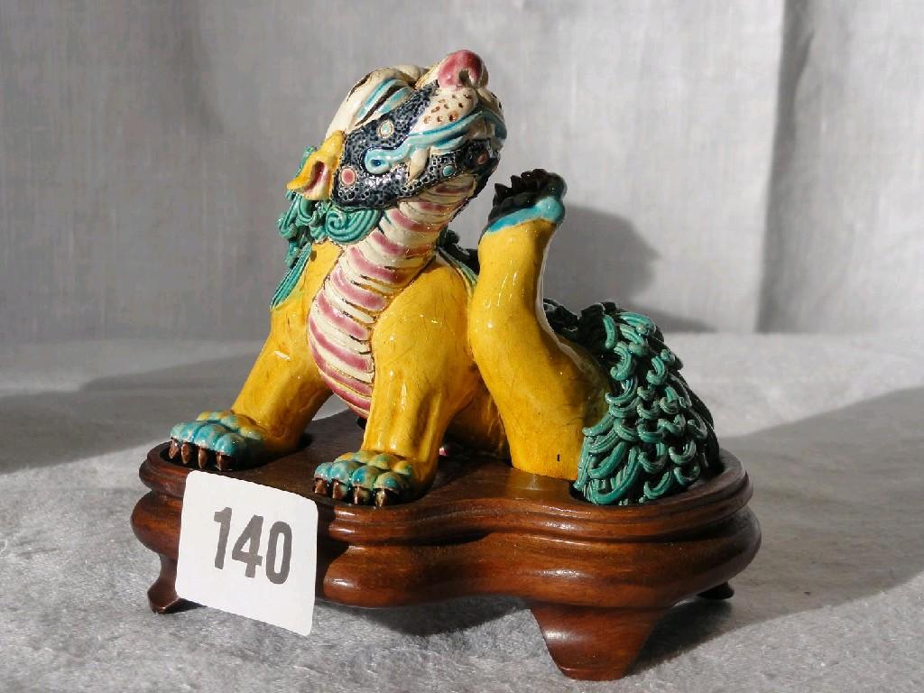 Appraisal: An oriental model of a scratching seated dog of Fo