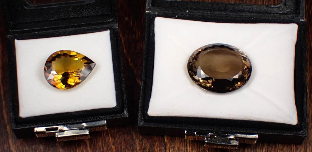 Appraisal: TWO UNSET SMOKY QUARTZ GEMSTONES including an cts oval-cut smoky