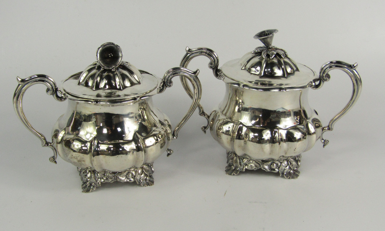 Appraisal: A pair of Indian white metal twin handled sucriers of