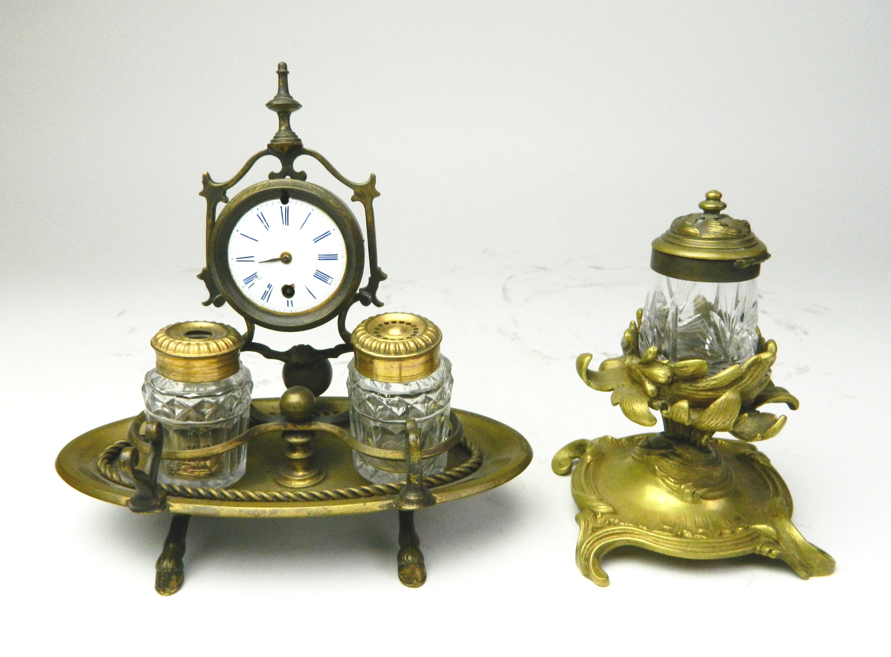 Appraisal: Ornate brass inkwells Double brass inkstand with central clock key