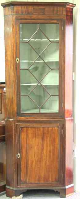 Appraisal: A Georgian and later mahogany corner cupboard with astragal glazed