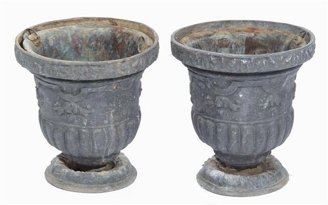 Appraisal: A PAIR OF ANTIQUE LEAD URNS with raised foliate and