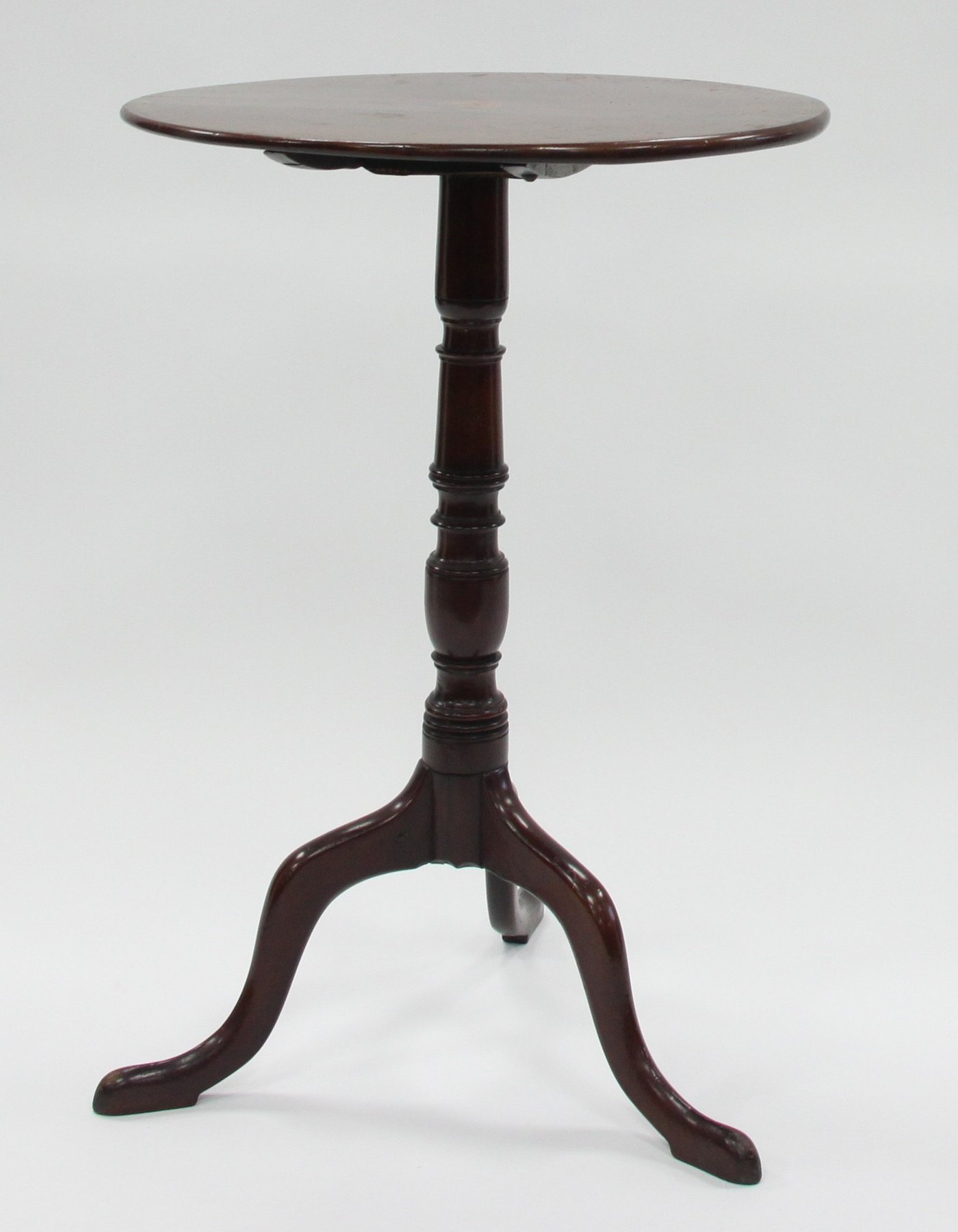 Appraisal: A circular mahogany table on a turned column with tripod