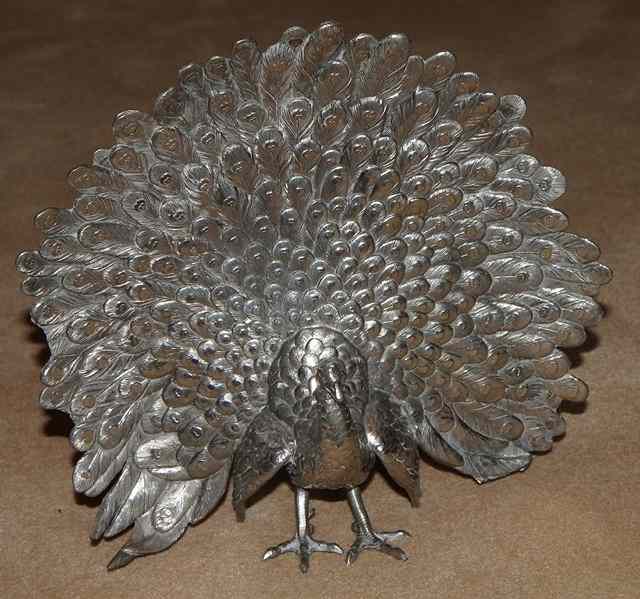 Appraisal: A WHITE METAL MODEL OF A PEACOCK in full display