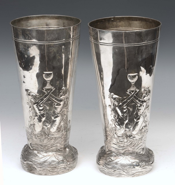 Appraisal: A PAIR OF SILVER VASES of tapering form chased with