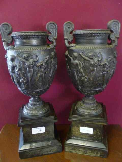 Appraisal: A PAIR OF VICTORIAN BLACK SLATE STANDS supporting cast urns