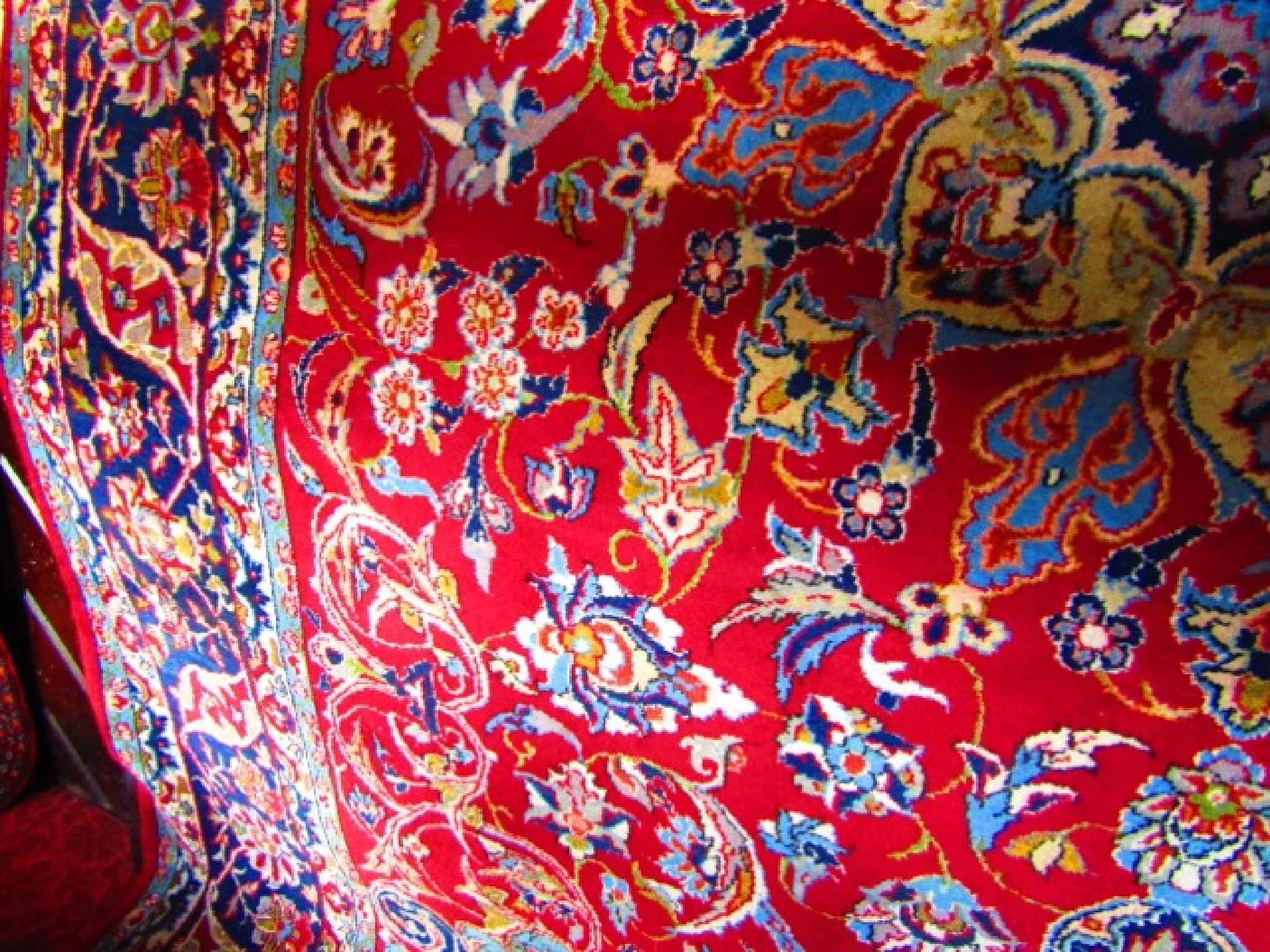 Appraisal: A substantial eastern wool carpet with deep red ground with