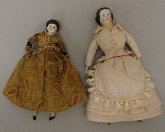 Appraisal: Pair of china dolls with black hair Lowbrow is wearing