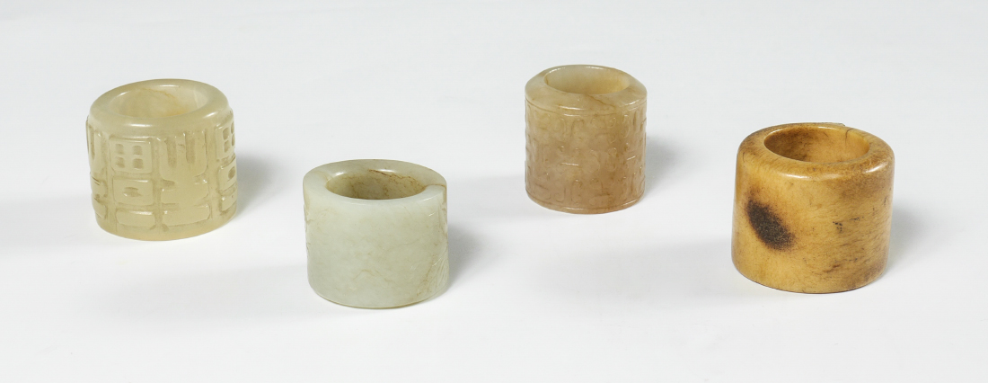 Appraisal: COLLECTION OF CARVED STONE ARCHERS' RINGS carved jade or similar