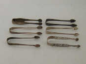 Appraisal: Five pairs of George III silver sugar tongs comprising a