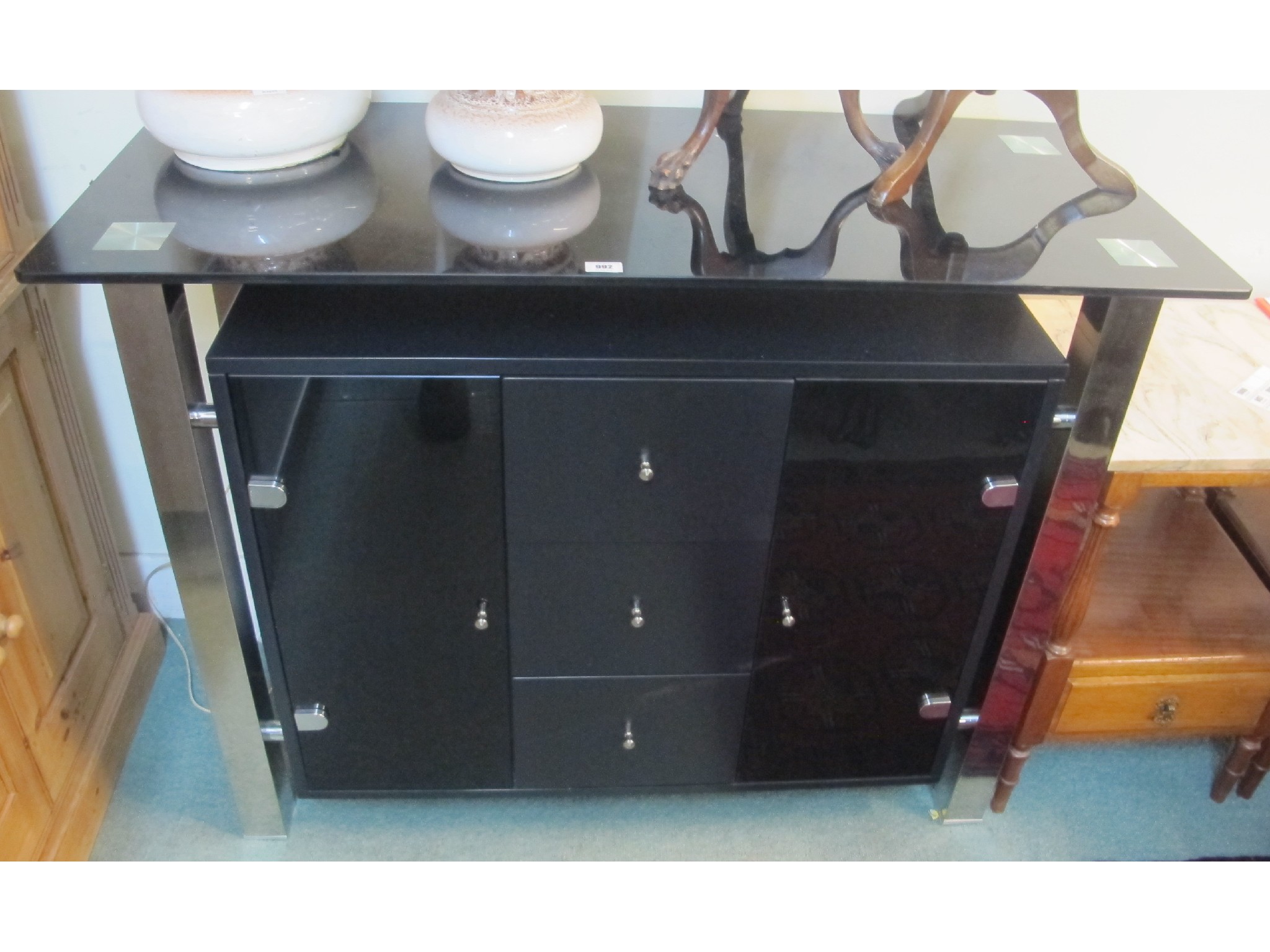 Appraisal: Black glass and metal cabinet