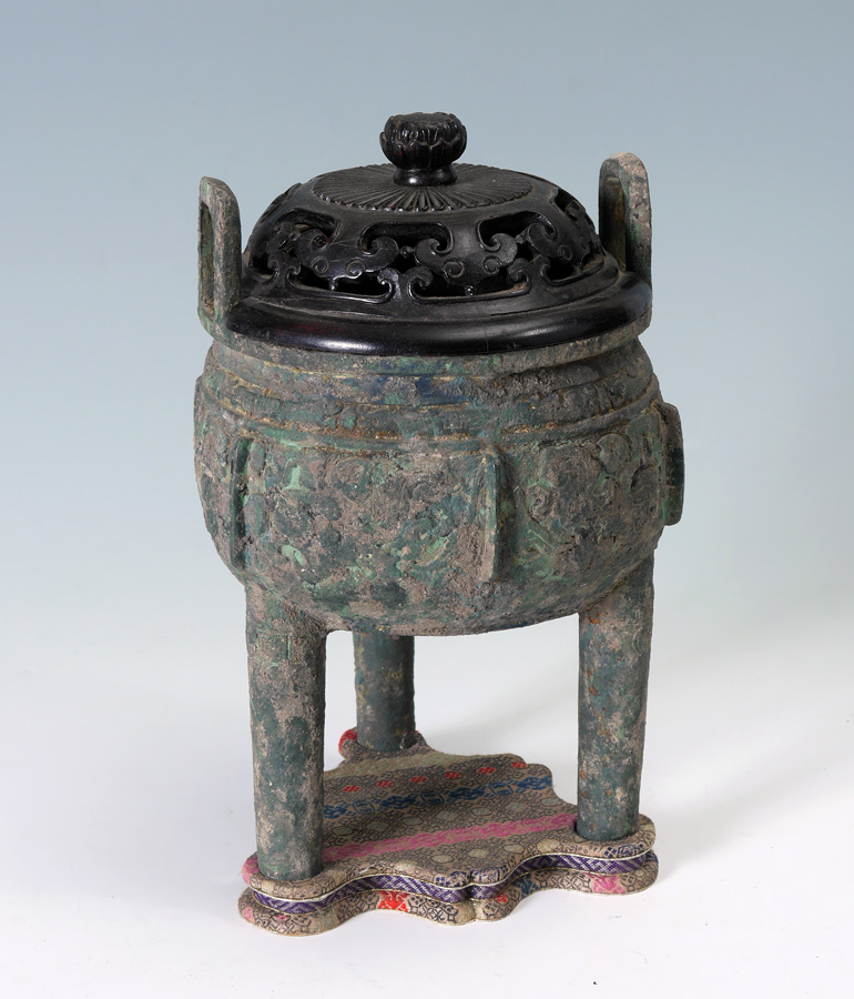 Appraisal: CHINESE ARCHAIC BRONZE COVERED VESSEL Carved and pierced wood lid