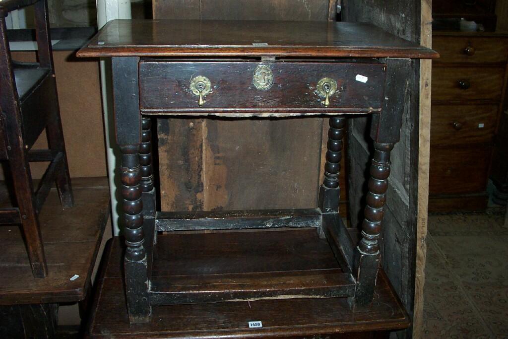 Appraisal: An th century oak side table fitted with a single