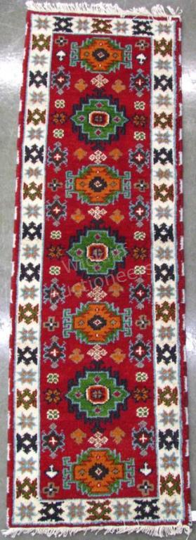 Appraisal: Handmade oriental Runner Kazak design red field with green and