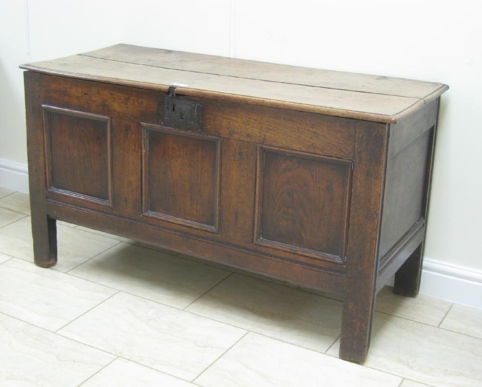 Appraisal: An antique oak Coffer with three panelled front ft in