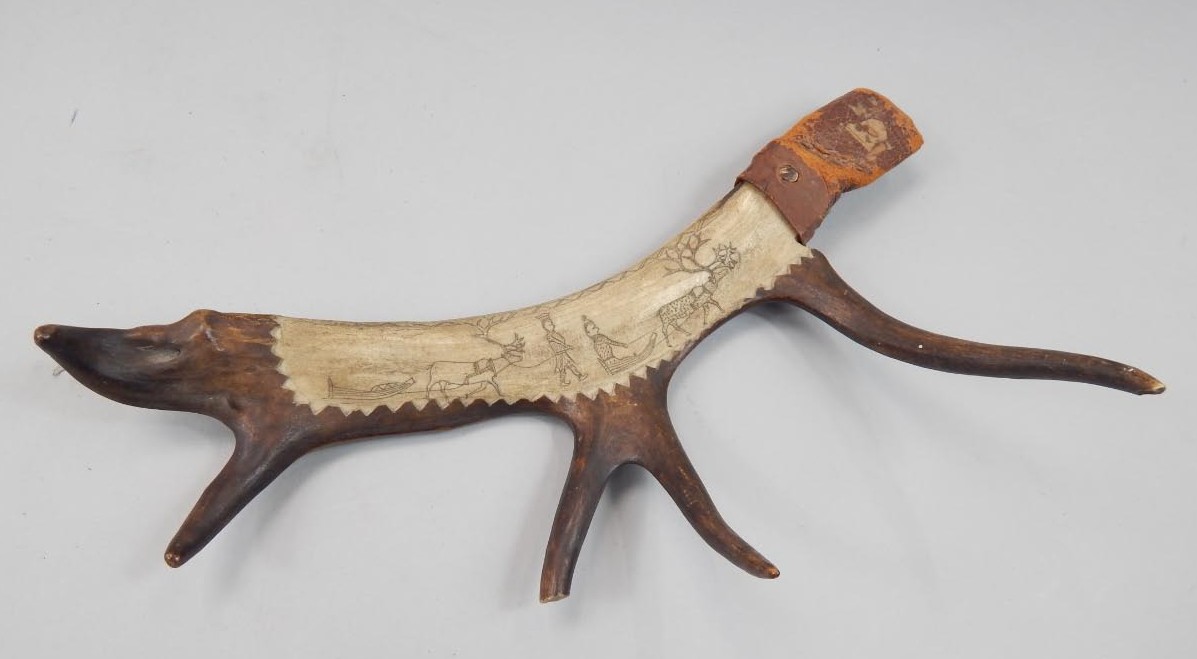 Appraisal: An Inuit antler scabbard with scrimshaw decoration of a reindeer