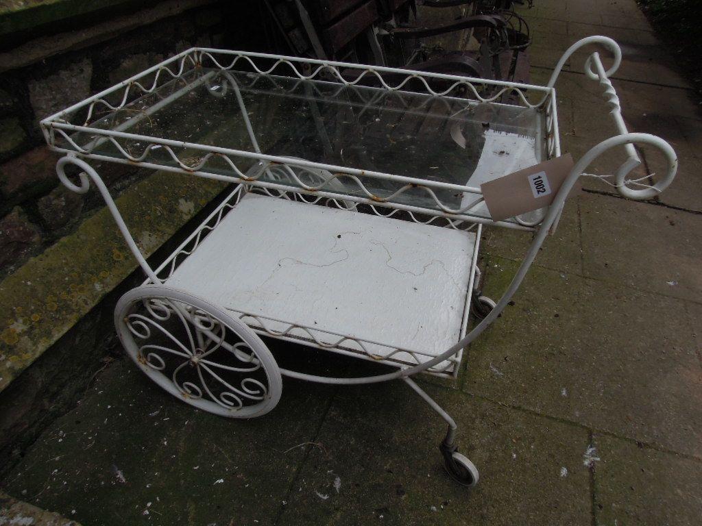 Appraisal: A decorative two tier drinks trolley cart with scroll work