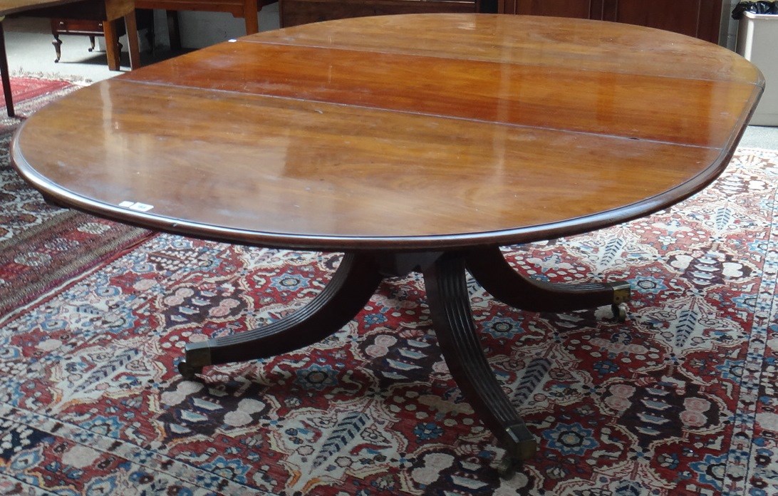 Appraisal: A George III mahogany extending dining table the oval top